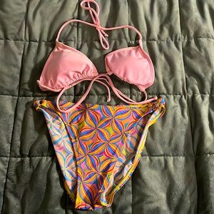 Pink bathing suit top and multi colored bottoms size small